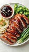 Sliced Peking Duck Served with Pancakes, Green Onions, and Chili Peppers photo