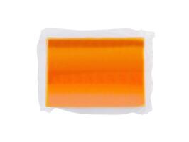 Vacuum packed block of cheddar cheese isolated on white background photo