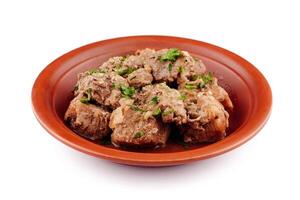 Stewed pork meat with herbs and spices on a plate photo