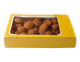 Cardboard box full of round crispy cookies with nuts on white background photo