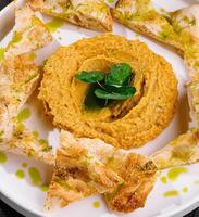 Gourmet hummus plate with pita chips photo