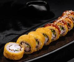 Exquisite sushi platter on dark slate background photo