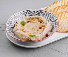Classic hummus with toasted bread photo