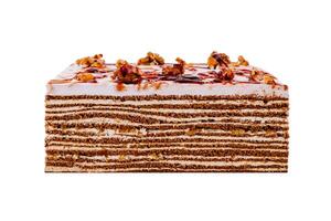 Delicious cake topped with walnuts and caramel drizzle on white background photo