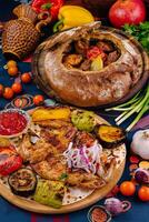 Traditional georgian cuisine with grilled chicken, vegetables and baked bread on table photo