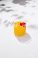 Refreshing summer cocktail with strawberry garnish casting shadows photo