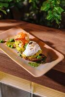 Two slices of avocado toast being served on a plate photo