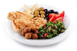 Plate presenting a colorful and tasty middle eastern mezze platter with various dips and salads photo