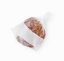 Freshly baked loaf of bread in a plastic bag with a blank label for branding photo