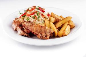 Grilled chicken breast serving with roasted potato wedges and salad on white plate photo