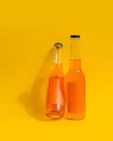 Two orange soda bottles leaning against yellow background photo