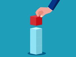 businessman hand putting red cube into the top of a stack of cubes vector
