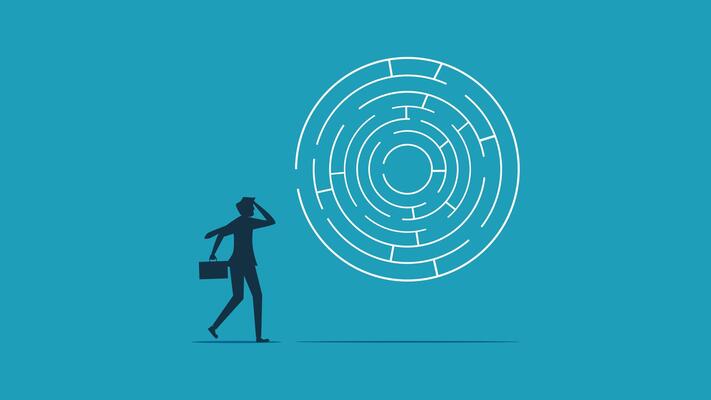 man looking at a maze with a person standing in front of it