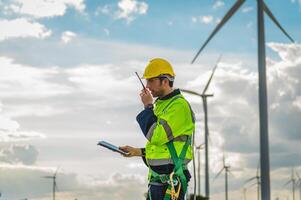 man in a yellow vest is talking on a walkie talkie while standing in front of photo