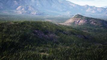 landscape with rolling hills and majestic mountains in the distance video