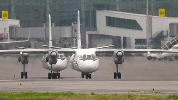 Turboprop aircraft in front of an airport terminal. Planes queued for takeoff. Travel concept video