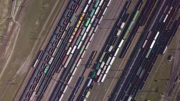 Aerial view of Railway sorting station and A lot of wagons at a railway. Drone flies over railway tracks. 4k quality video
