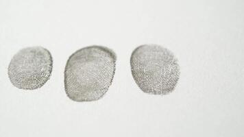 Three fingerprints are shown on a white surface video