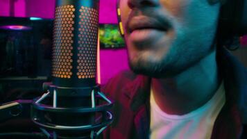 Close up face Indian Arabian Latino American man player streamer game mouth shouting scream tell explain talk microphone guy network esport cyberspace computer speak technology web online male video