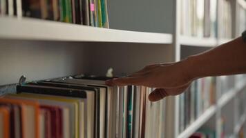 Close up hand African American man choose book bookshelf library bookstore student university unrecognizable reader literature textbooks literary bookworm bookcase education learn buyer shopper books video