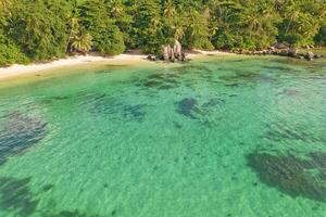 Drone aerial shot of Anse royale, fairy land of beautiful white sandy beach with granite stones and lush greenery, Mahe Seychelles photo