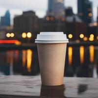 cardboard brown coffee cup without labels with a plastic lid on a blurred urban background with skyscrapers in the distance photo