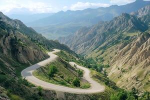 Twisting Mountain Road with Sharp Hairpin Curves and Breathtaking Valley Views, Framed by a Clean White Background photo