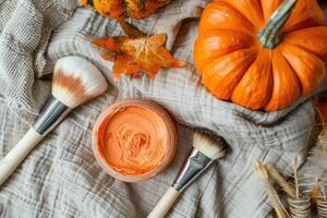 Pumpkin face mask, top view, with pumpkin, brush and autumn leaves. photo