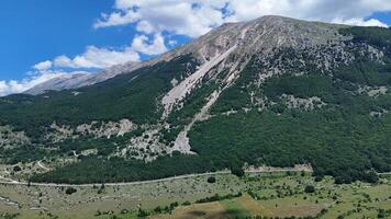 Breathtaking mountain landscape in the afternoon light reveals lush greenery and rugged terrain in a remote valley photo