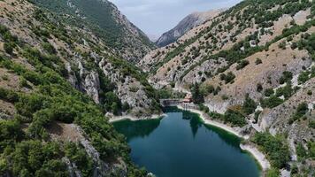 Breathtaking view of a serene lake surrounded by rugged mountains during a tranquil midday in nature s embrace photo