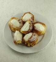 eclairs with vla or custard filling served on a plate photo