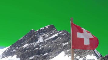 Swiss flag blow and mt.Jungfraujoch against green screen background. Aerial view of red flag of Switzerland and Jungfraujoch crest which is Top of Europe highest mountain Swiss Alps with greenscreen. video
