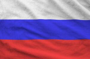 Russia flag depicted on folded wavy fabric of old cloth photo