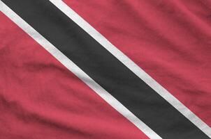 Trinidad and Tobago flag depicted on folded wavy fabric of old cloth photo