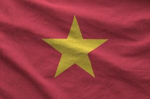 Vietnam flag depicted on folded wavy fabric of old cloth photo