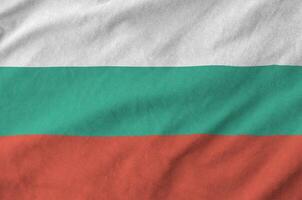 Bulgaria flag depicted on folded wavy fabric of old cloth photo