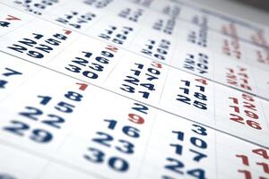sheets of wall calendar with the number of days photo
