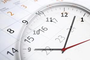 sheet of a calendar with the number of days and clock photo