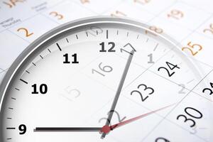 sheet of a calendar with the number of days and clock photo
