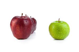maroon apples lined up in a row and green apple closeup photo