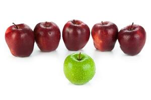 maroon apples lined up in a row and green apple closeup photo