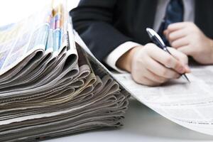 stack of newspapers in office close-up photo