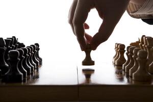 man makes a move chess pawn photo