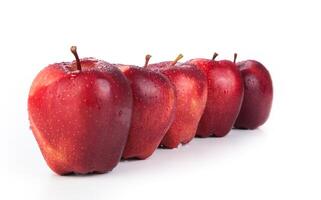 maroon apples lined up in a row closeup photo