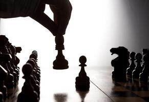 man makes a move chess figure photo