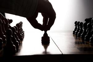 man makes a move chess figure photo