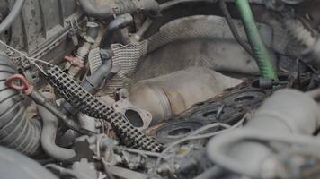 Auto mechanic serviceman assembles the car engine and installs the piston with new rings video