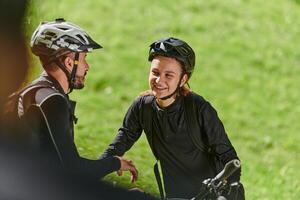 A sweet couple, equipped with bicycles and engrossed in coordinating their journey, checks their GPS mobile and watches while planning scenic routes in the park, seamlessly blending technology and photo