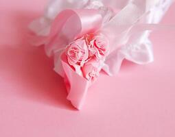 The bride's garter on a pink background. photo