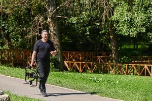 After completing a cinematic venture, a skilled videographer, adorned with camera equipment, leisurely strolls through the park, capturing the essence of post-production satisfaction and creative photo